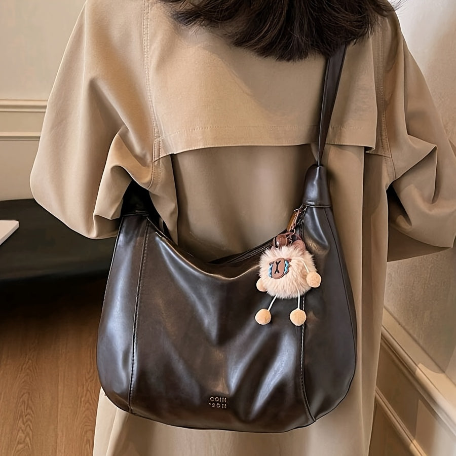 Sac bandoulière vintage élégant pour femmes – grand format, bandoulière réglable, charm lion en peluche, fermeture zippée, détails sur les bords, simili cuir café, marron clair ou noir, idéal pour travail, trajets et sorties