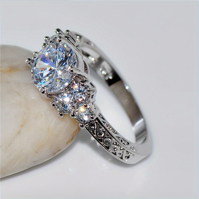 A Luxurious Engagement Ring for Women Featuring Intricate Carvings And Set with Sparkling Cubic Zirconia, Perfect for Brides at Weddings, Parties, Or Everyday Wear; a Romantic Proposal Ring.