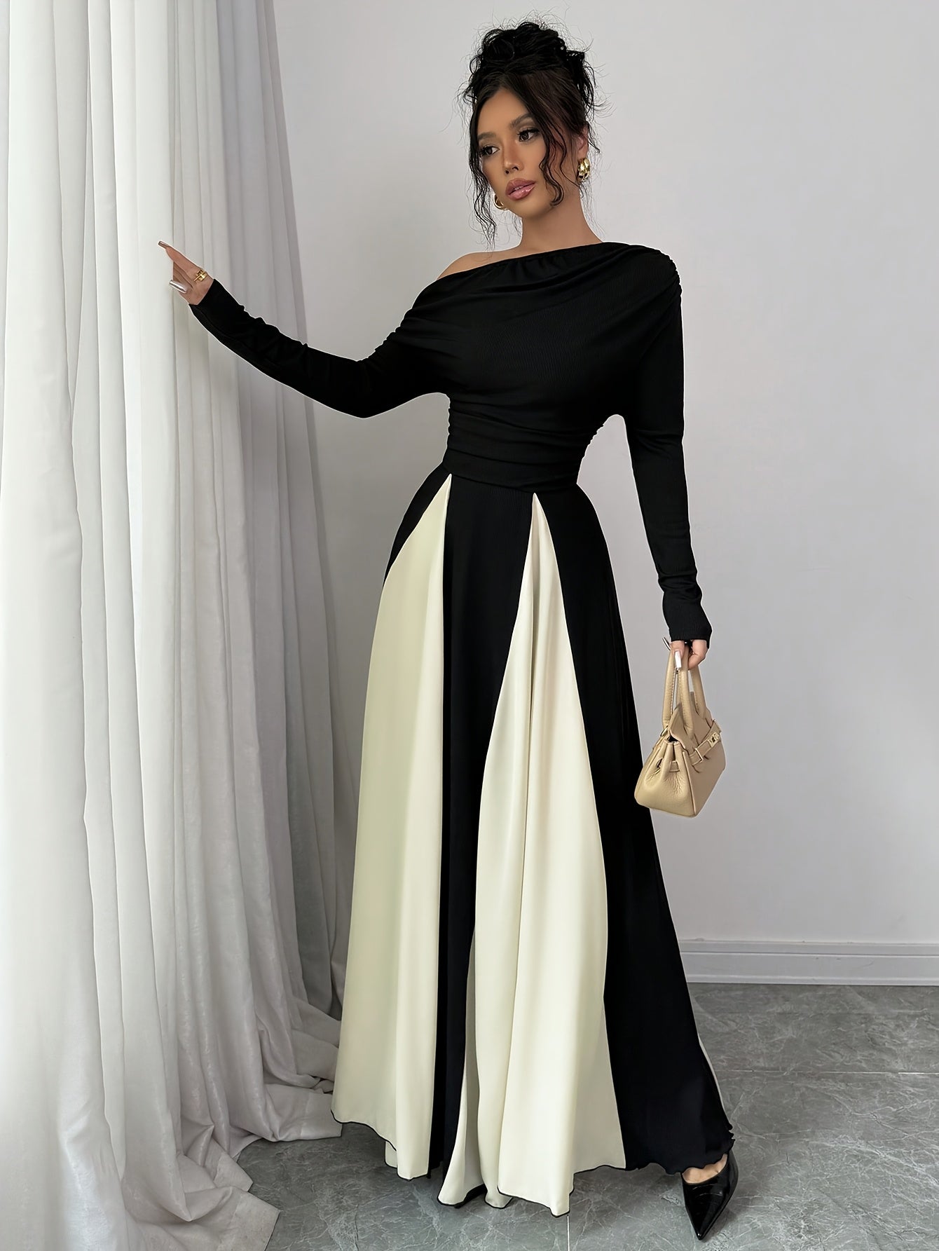 A Stylish And Elegant Long-Sleeve Dress with a Slanted Shoulder, Featuring Fine Ribbing, a Fitted Waist, And a Flared Hem, Perfect for Autumn And Winter.