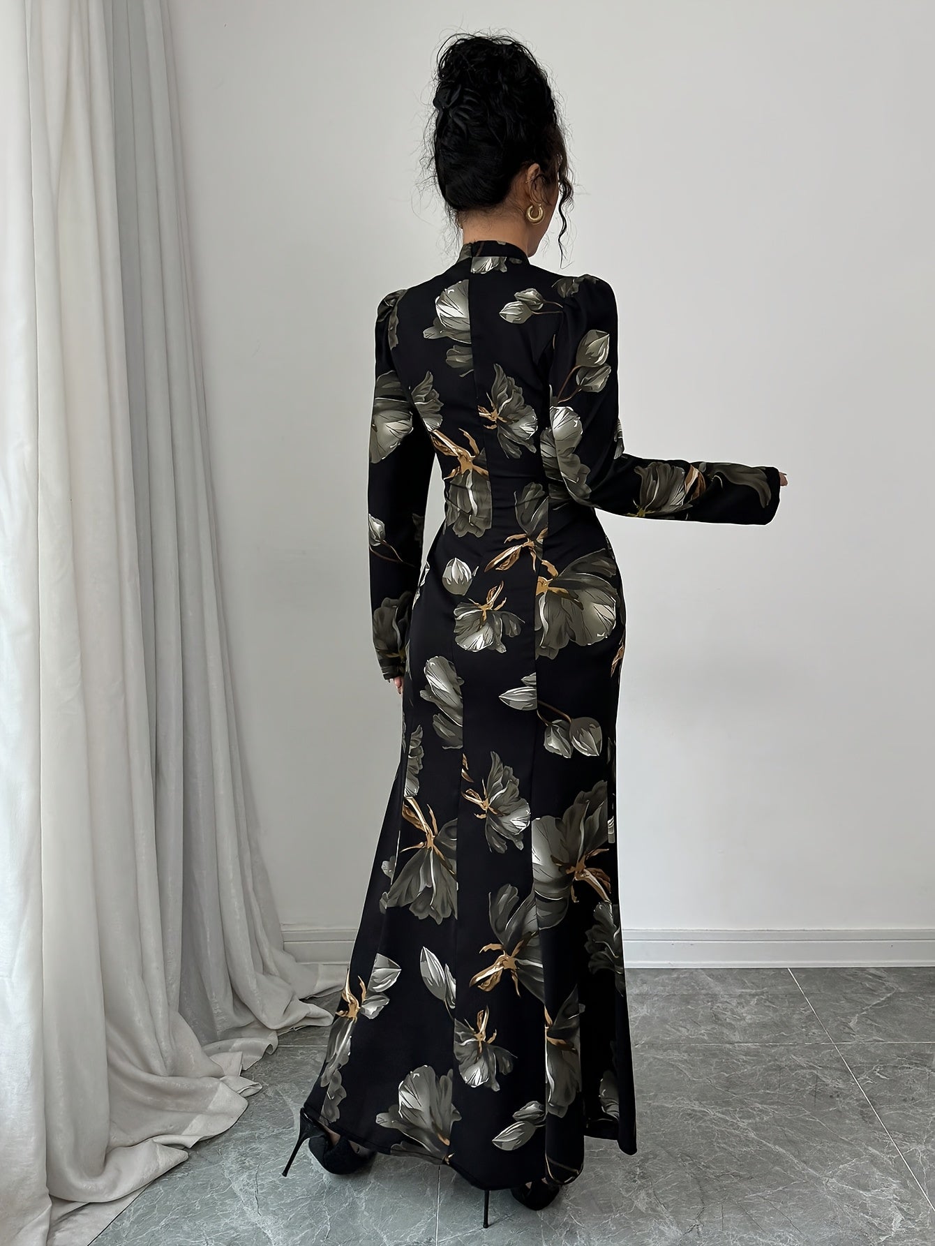 Robe maxi élégante à imprimé floral – manches longues, détail nœud au dos, taille cintrée, ourlet asymétrique, noire avec fleurs bleues, idéale automne/hiver, mode femme adulte, robe fleurie